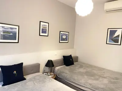 a bedroom with two beds and a lamp at Cannes Old Port, SEAFRONT & SEAVIEWS new reversible air conditioning in Cannes