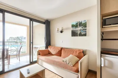 a living room with a couch and a balcony at Résidence Cannes Villa Francia - maeva Home - Appartement 2 pièces 4 personnes - Sélection MAE-6529 in Cannes