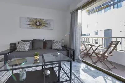 a living room with a couch and a table at Cannes Palm Beach district 2 min to the beaches in Cannes