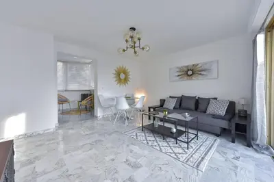 a living room with a couch and a table at Cannes Palm Beach district 2 min to the beaches in Cannes