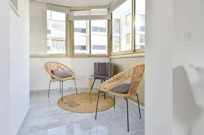 two chairs and a table in a room with windows at Cannes Palm Beach district 2 min to the beaches in Cannes