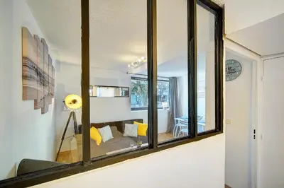 a living room with a mirror on the wall at Le Dol - 150m plages - Suquet - Verrière Côte d'azur in Cannes