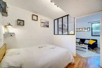 a white bedroom with a bed and a window at Le Dol - 150m plages - Suquet - Verrière Côte d'azur in Cannes