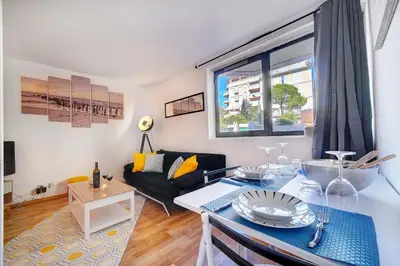 a living room with a table and a couch at Le Dol - 150m plages - Suquet - Verrière Côte d'azur in Cannes