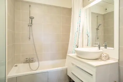 a bathroom with a sink and a shower and a tub at Parc Eugenie by Welcome to Cannes in Cannes