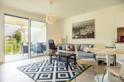 a living room with a couch and a table at Parc Eugenie by Welcome to Cannes in Cannes