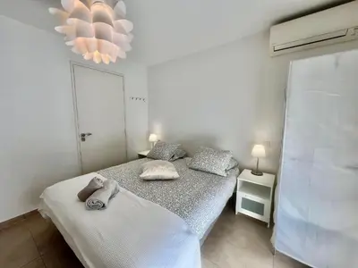a bedroom with two beds with towels on them at Parc Eugenie by Welcome to Cannes in Cannes