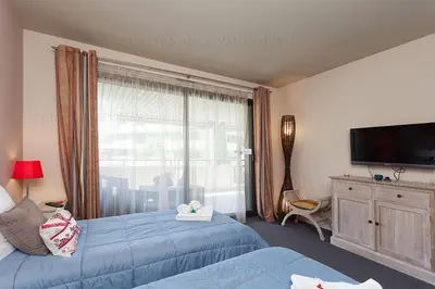 a bedroom with two beds and a large window at gray 3a2 in Cannes