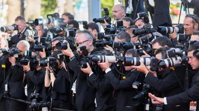 a group of journalists taking photos with cameras at gray 3a2 in Cannes