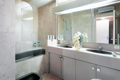 a bathroom with two sinks and a large mirror at gray 3a2 in Cannes