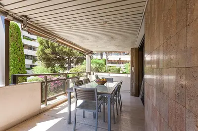 a patio with a table and chairs on a balcony at gray 3a2 in Cannes