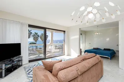 a living room with a couch and a view of the ocean at Louis 2 in Cannes
