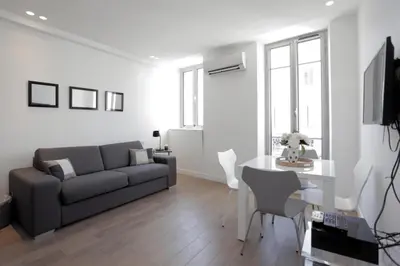 a living room with a couch and a table at C004-Cosy studio proche la Croisette et le Suquet in Cannes