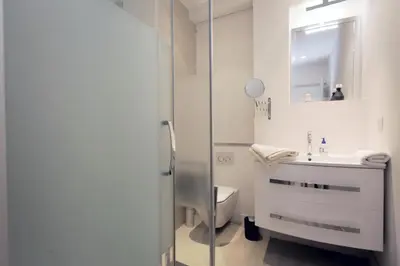 a bathroom with a toilet and a sink and a mirror at C004-Cosy studio proche la Croisette et le Suquet in Cannes
