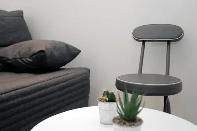 a living room with a couch and a table with a stool at C005-Studette au centre Cannes in Cannes