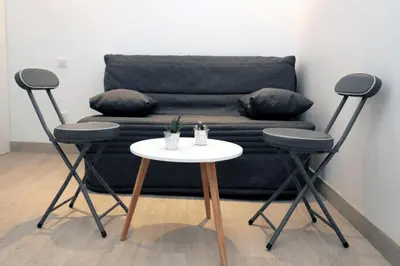 a table and two chairs in front of a couch at C005-Studette au centre Cannes in Cannes