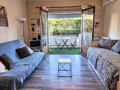 a living room with two couches and a table at CANNES STUDIO - wifi, clim in Cannes