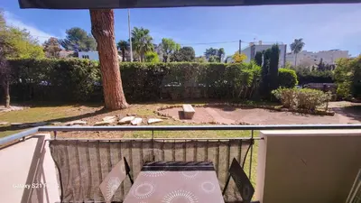a view of a backyard with a table and a tree at CANNES STUDIO - wifi, clim in Cannes