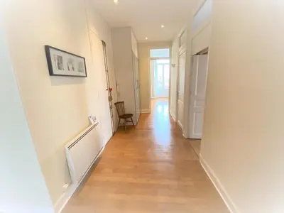 a hallway with white walls and a wooden floor at Centre Ville Calme Festivales Plages in Cannes