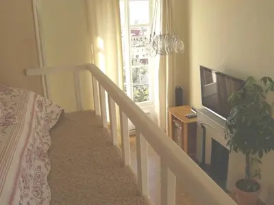 a room with a staircase with a television and a bed at Centre Ville Calme Festivales Plages in Cannes