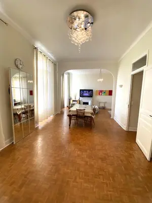 an empty living room with a table and a chandelier at Centre Ville Calme Festivales Plages in Cannes