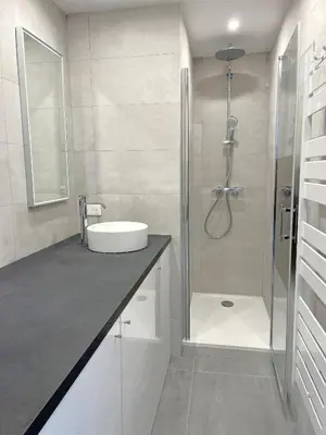 a bathroom with a shower with a sink and a sink at Solezia appartement, piscine et vue mer, by Welcome to Cannes in Cannes