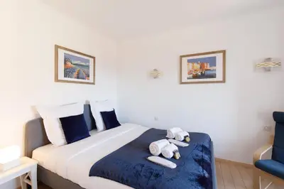 a bedroom with a bed with towels on it at Alexandra YourHostHelper in Cannes