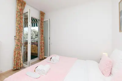 a bedroom with a bed with two slippers on it at Alexandra YourHostHelper in Cannes