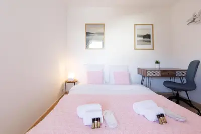 a bedroom with a bed and a desk and a chair at Alexandra YourHostHelper in Cannes