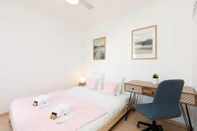 a bedroom with a bed and a desk and a chair at Alexandra YourHostHelper in Cannes