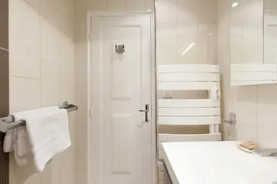 a white bathroom with a sink and a toilet at Alexandra YourHostHelper in Cannes