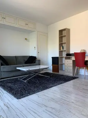 a living room with a couch and a table at Cannes Standing proche Croisette in Cannes