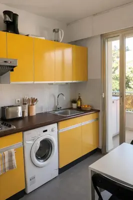 a kitchen with a washing machine and a sink at Cannes Standing proche Croisette in Cannes