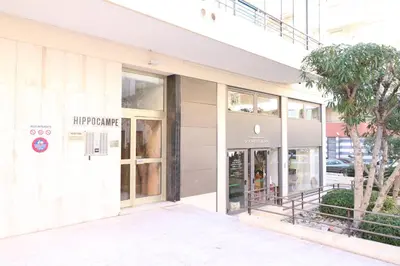 a facade of a building with the entrance to a store at Beautiful studio at the Grand Hotel Residence with sunny balcony 138 in Cannes