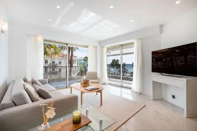 a living room with a couch and a table at Agence des Résidences - Appartements privés du 45 CROISETTE- Prestige in Cannes