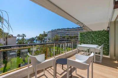 a balcony with a table and chairs and a view at Agence des Résidences - Appartements privés du 45 CROISETTE- Prestige in Cannes