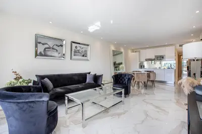 a living room with a couch and a table at Agence des Résidences - Appartements privés du 45 CROISETTE- Prestige in Cannes