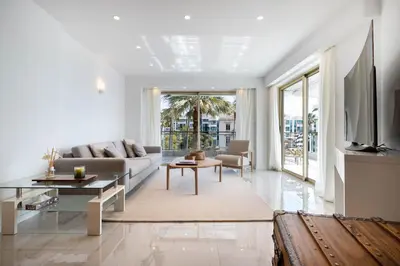 a living room with a couch and a table at Agence des Résidences - Appartements privés du 45 CROISETTE- Prestige in Cannes