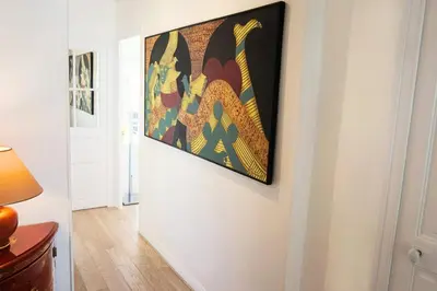 a painting hanging on a wall in a hallway at 2-Br City center near Croisette & Palais in Cannes
