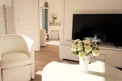 a living room with a vase of flowers on a table at 2-Br City center near Croisette & Palais in Cannes