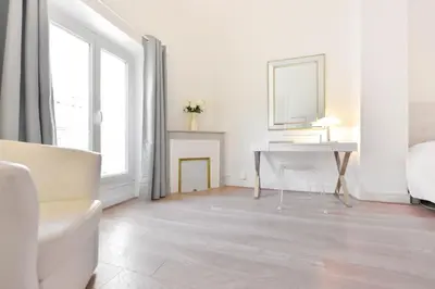 a white room with a desk and a mirror at 2-Br City center near Croisette & Palais in Cannes