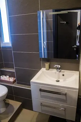 a bathroom with a white sink and a mirror at Appartement palais plages in Cannes