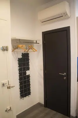 a black door in a room with a wall at Appartement palais plages in Cannes