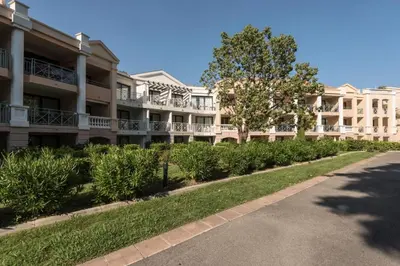 an apartment building with bushes in front of a street at Résidence Cannes Villa Francia - maeva Home - Appartement 2 pièces 6 personnes - Sélection MAE-6118 in Cannes