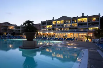 a large hotel with a swimming pool at night at Résidence Cannes Villa Francia - maeva Home - Appartement 2 pièces 6 personnes - Sélection MAE-6118 in Cannes