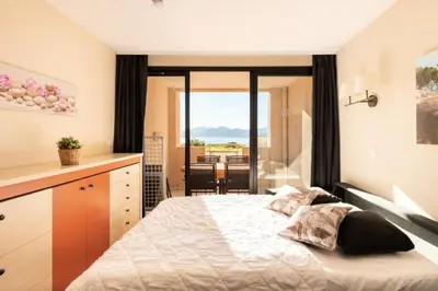 a bedroom with a large bed and a balcony at Résidence Cannes Villa Francia - maeva Home - Appartement 2 pièces 6 personnes - Sélection MAE-6118 in Cannes