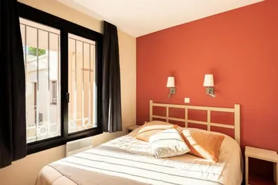a bedroom with a bed and a large window at Résidence Cannes Villa Francia - maeva Home - Appartement 2 pièces 6 personnes - Sélection MAE-6118 in Cannes