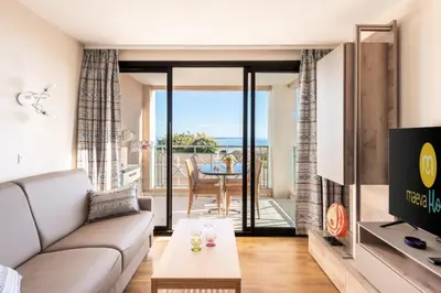 a living room with a couch and a tv and a table at Résidence Cannes Villa Francia - maeva Home - Appartement 3 pièces 6 personnes - Sélection MAE-8432 in Cannes