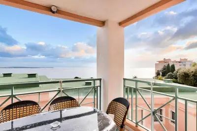 a balcony with a table and chairs and a view of the ocean at Résidence Cannes Villa Francia - maeva Home - Appartement 3 pièces 6 personnes - Sélection MAE-8432 in Cannes
