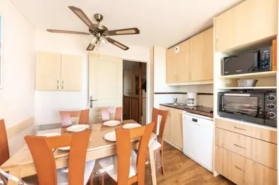 a kitchen and dining room with a table and chairs at Résidence Cannes Villa Francia - maeva Home - Appartement 3 pièces 6 personnes - Sélection MAE-8432 in Cannes